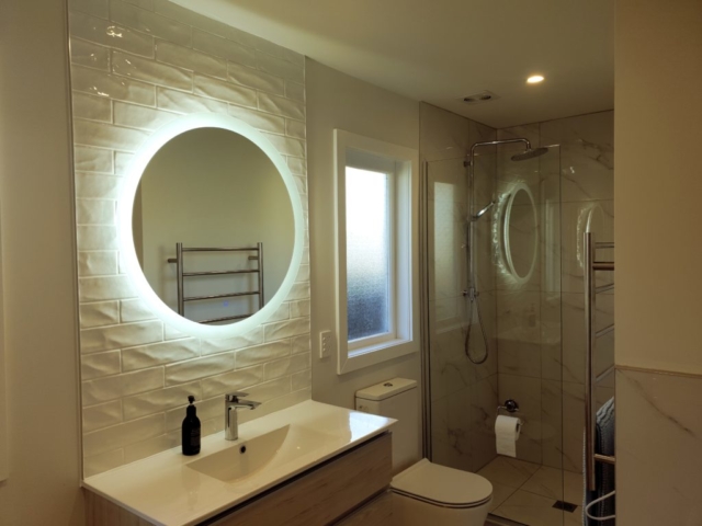 bathroom with round mirror